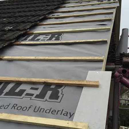 replacing old roof tiles with new ones
